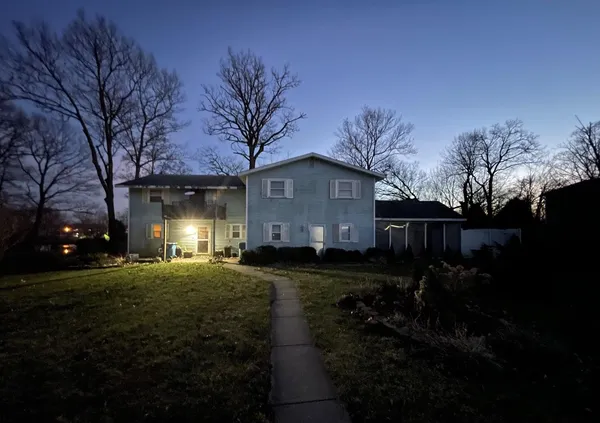 a front view of house with yard and green space