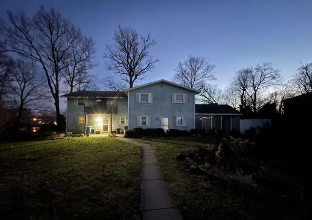 a front view of house with yard and green space