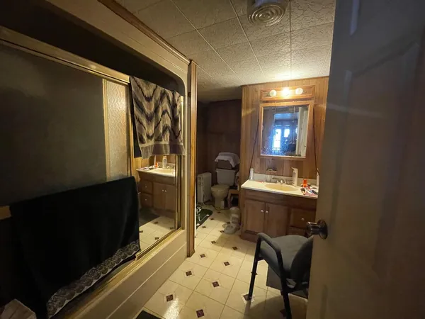 a bathroom with a sink mirror vanity and toilet
