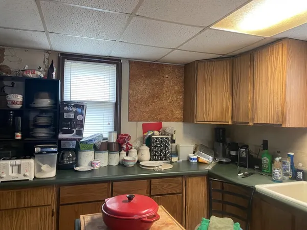 a kitchen with a sink cabinets and window