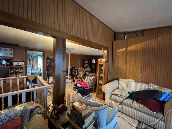 a living room with furniture and a air conditioner vent