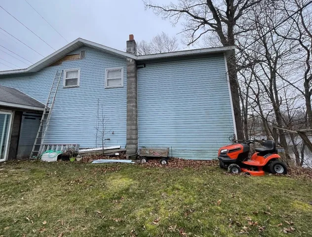 a couple of cars parked in front of a house