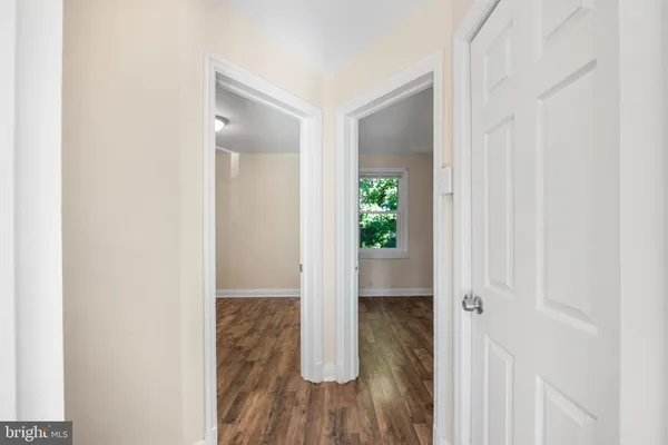 a view of hallway with wooden floor