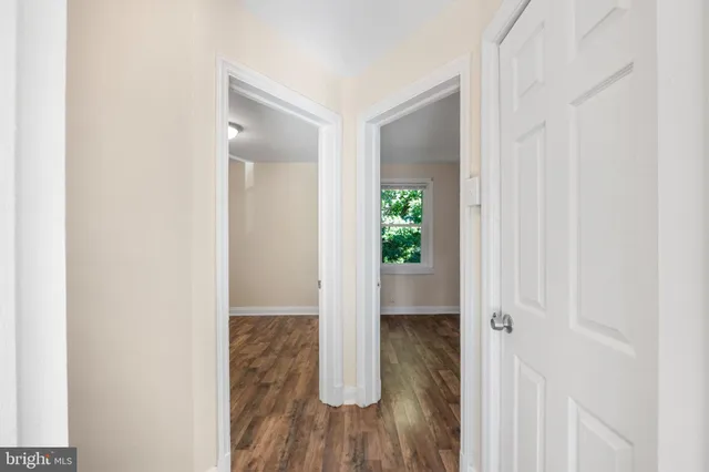 a view of hallway with wooden floor