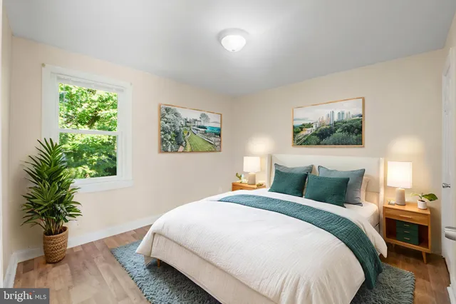 a bedroom with bed and a potted plant