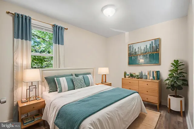 a bedroom with a large bed and a potted plant