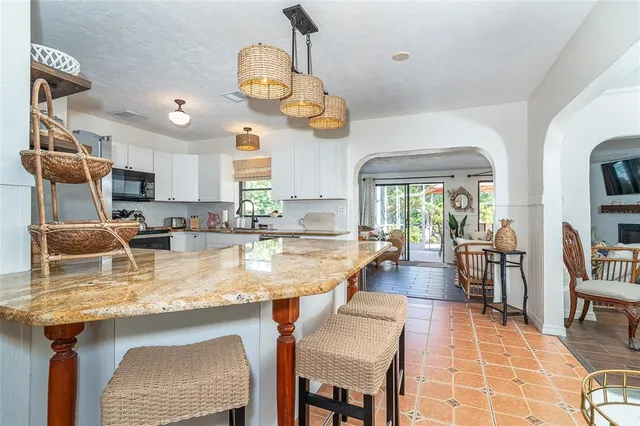 a view of a dining room with furniture wooden floor and chandelier