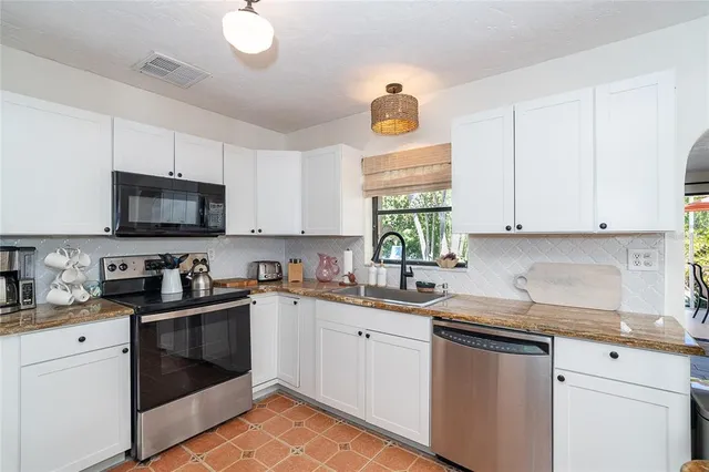 a living room with furniture fireplace and a large window