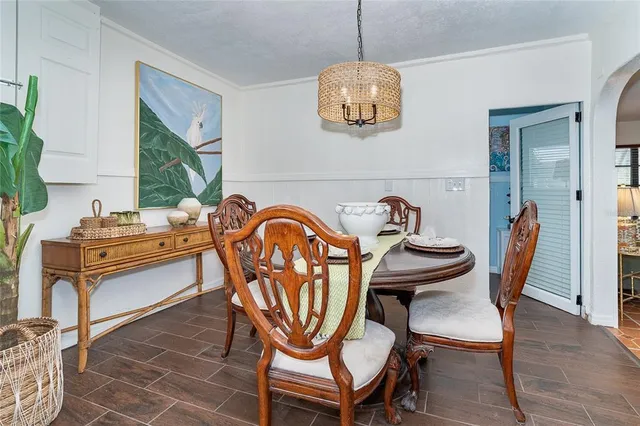 a view of a patio with a table chairs and a potted plant