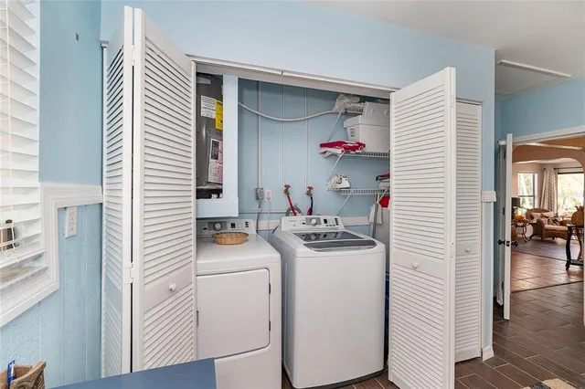 an aerial view of residential houses with outdoor space and lake view