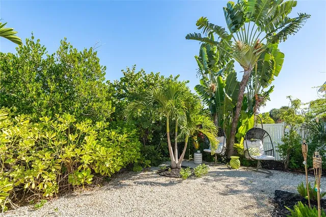 an aerial view of a house with a garden and lake view