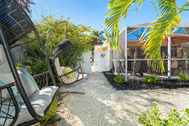 an aerial view of water body with boats and residential houses with outdoor space