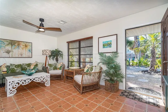 a kitchen with kitchen island granite countertop a sink a stove a refrigerator cabinets and chairs