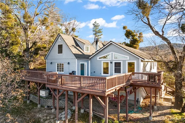 a view of a house with a yard and potted plants