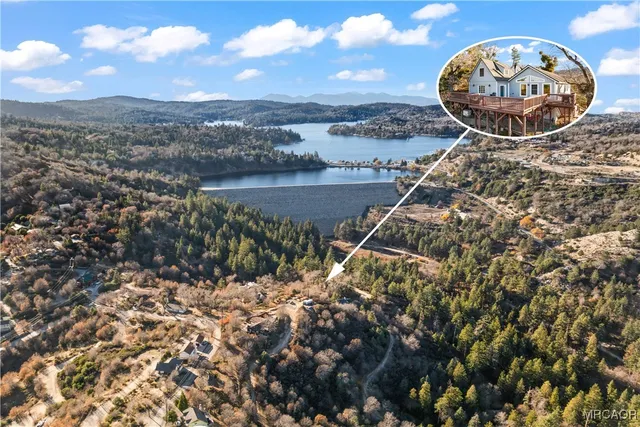 an aerial view of a house with a backyard