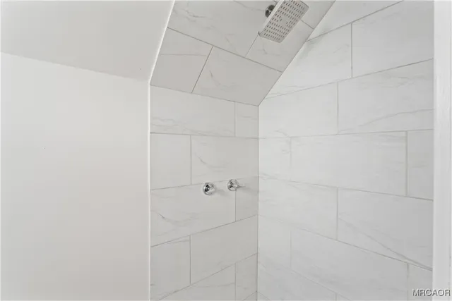 a view of a balcony with wooden floor and fence