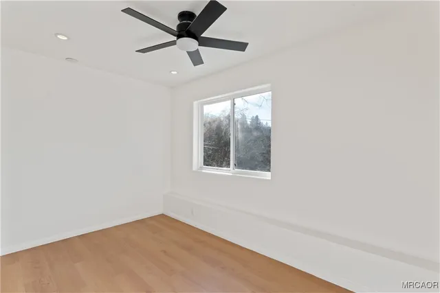 an empty room with closet and windows