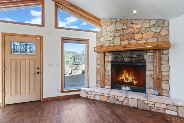 a kitchen with stainless steel appliances granite countertop wooden cabinets a dining table and chairs