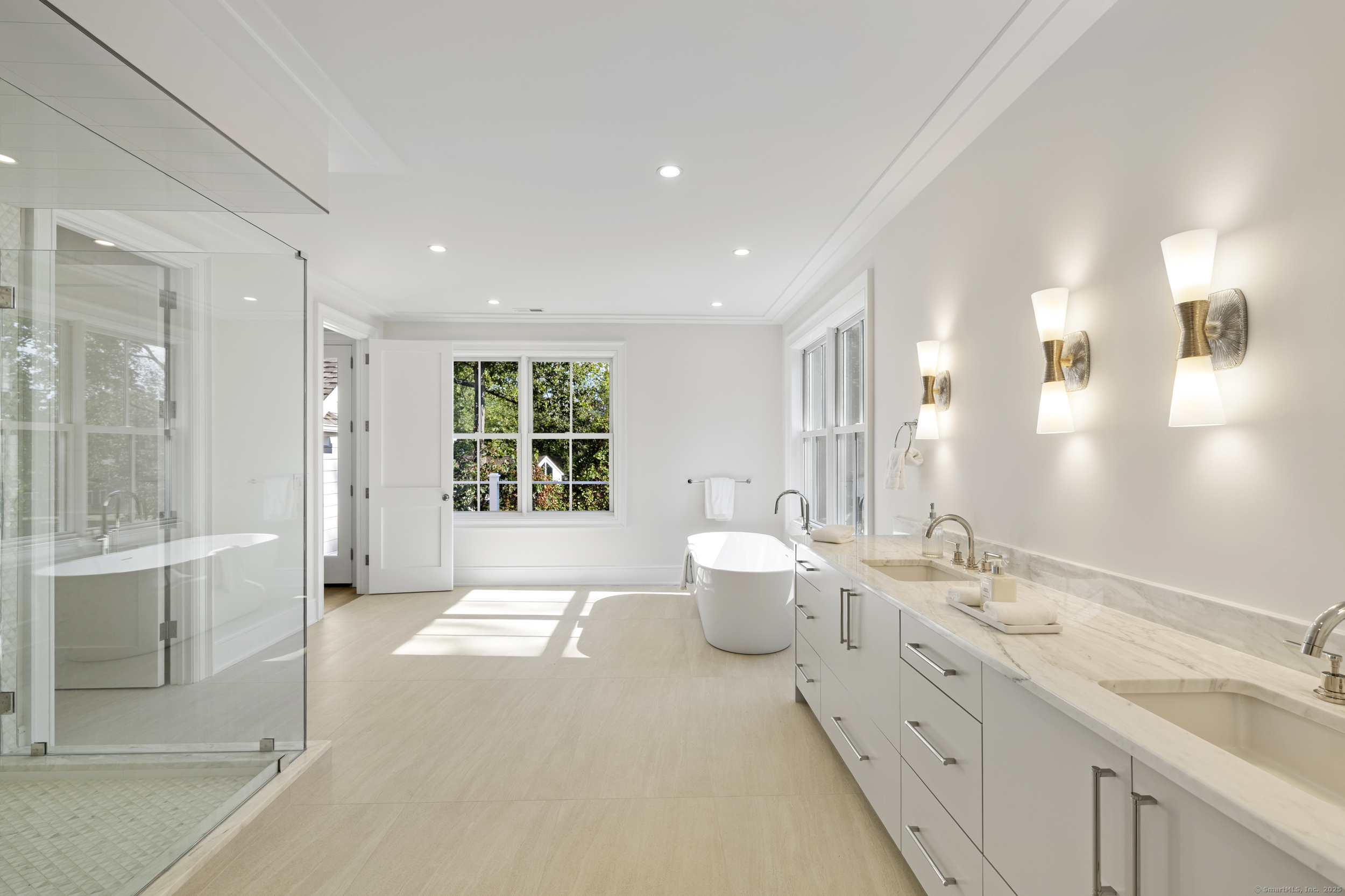 32 Webb Road Westport, CT 06880 - Photo 16 of 40 a spacious bathroom with a double vanity sink a large mirror and a shower