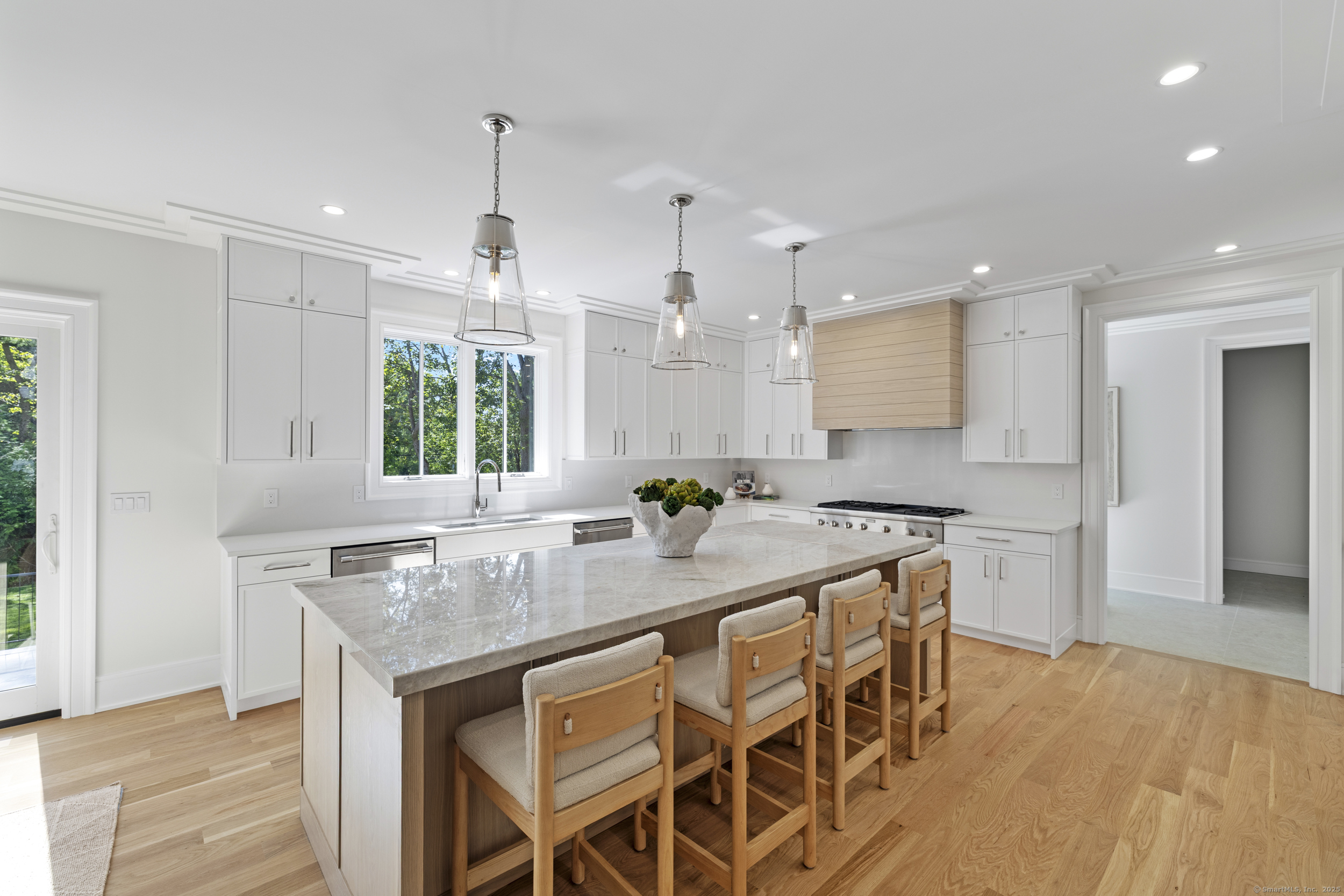 32 Webb Road Westport, CT 06880 - Photo 2 of 40 a kitchen with kitchen island granite countertop a sink and a refrigerator