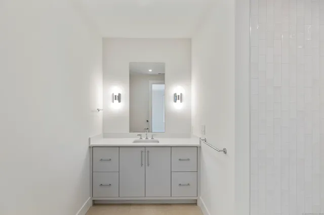 a bathroom with a sink a mirror and a window