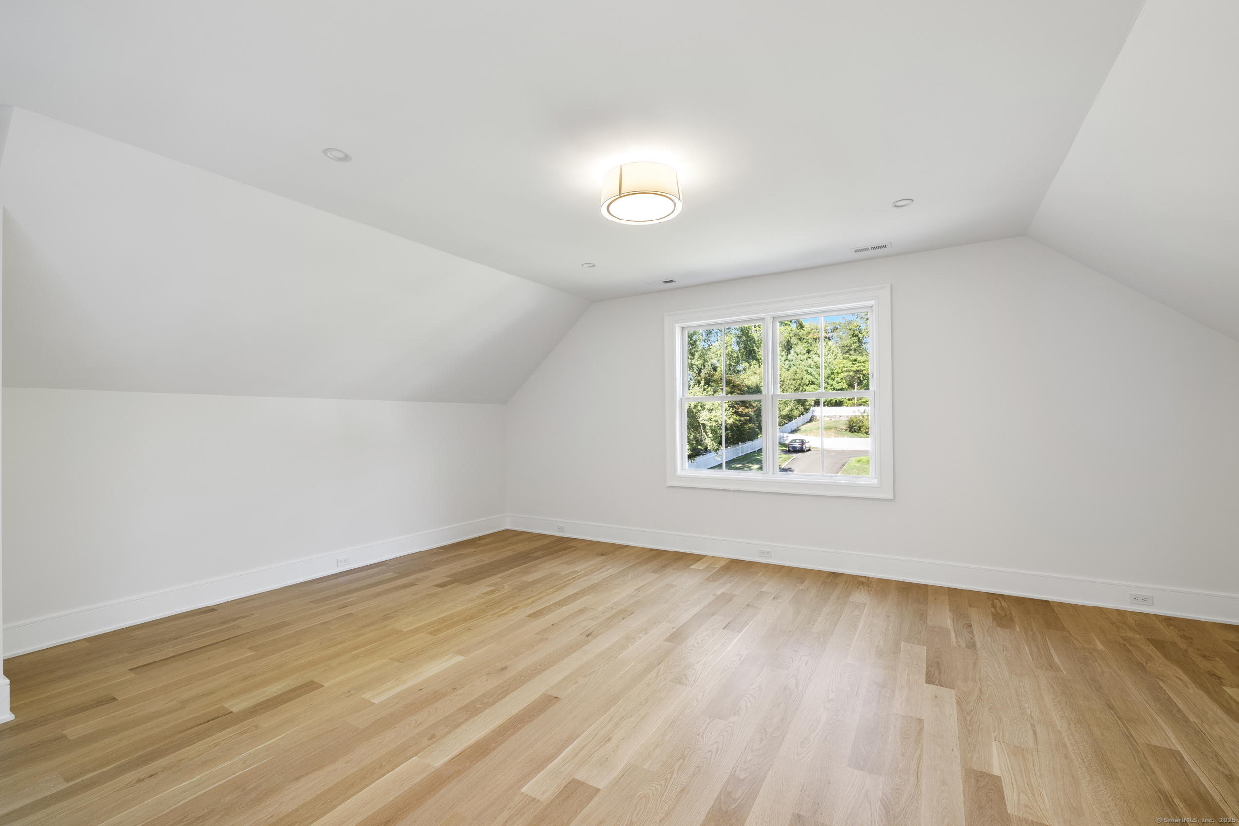 32 Webb Road Westport, CT 06880 - Photo 28 of 40 an empty room with wooden floor and windows