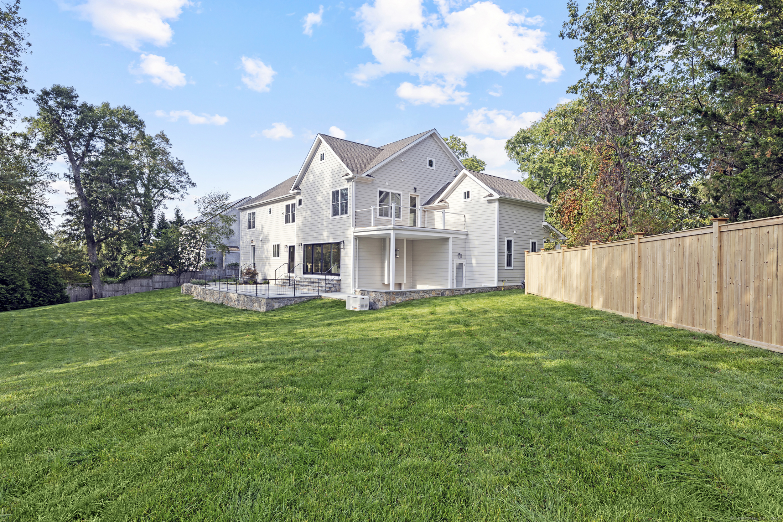 32 Webb Road Westport, CT 06880 - Photo 35 of 40 a view of a big house with a big yard and large trees