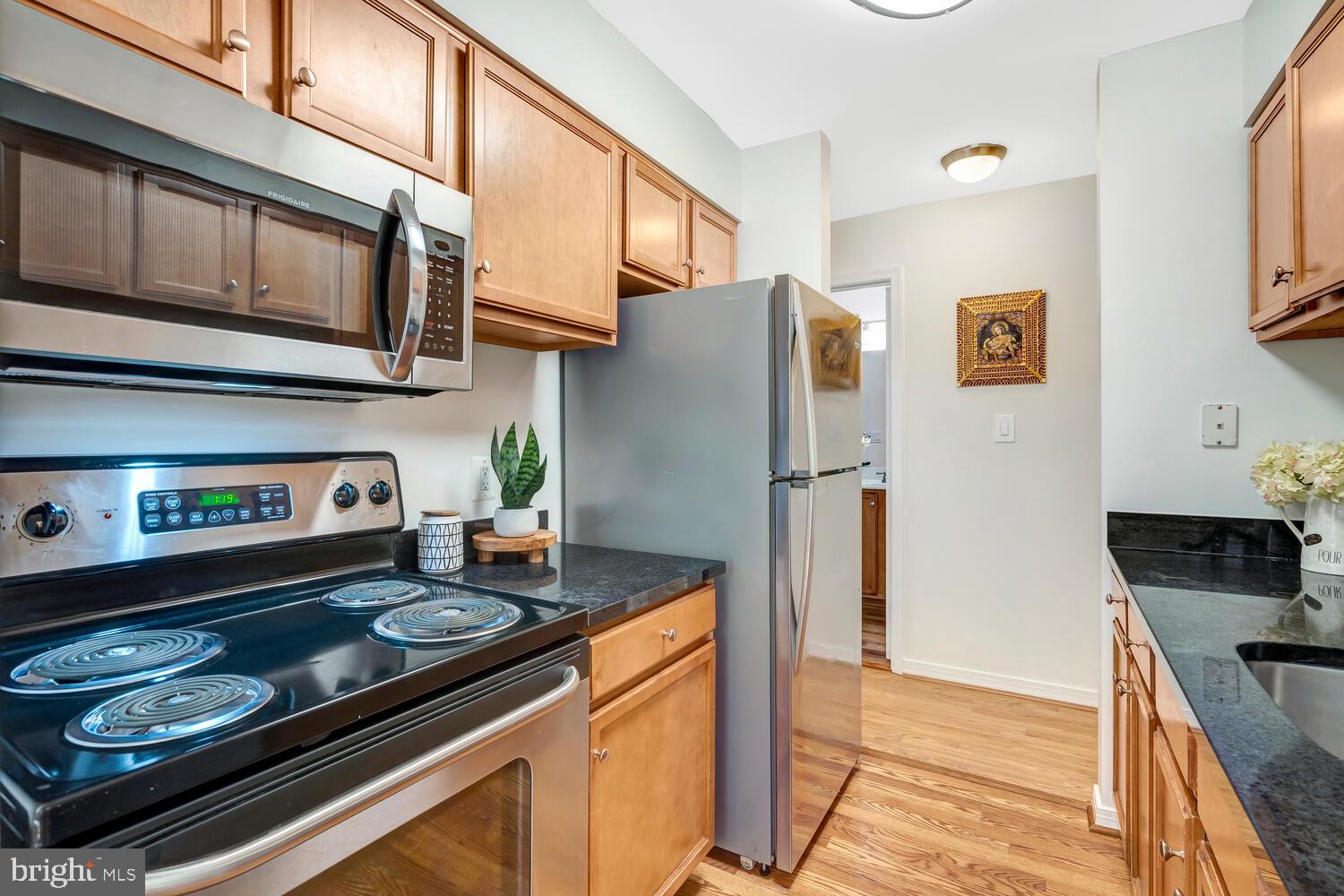 1791 Jonathan Way, Unit 1791C Reston, VA 20190 - Photo 12 of 58 a kitchen with stainless steel appliances granite countertop a stove a refrigerator and a microwave