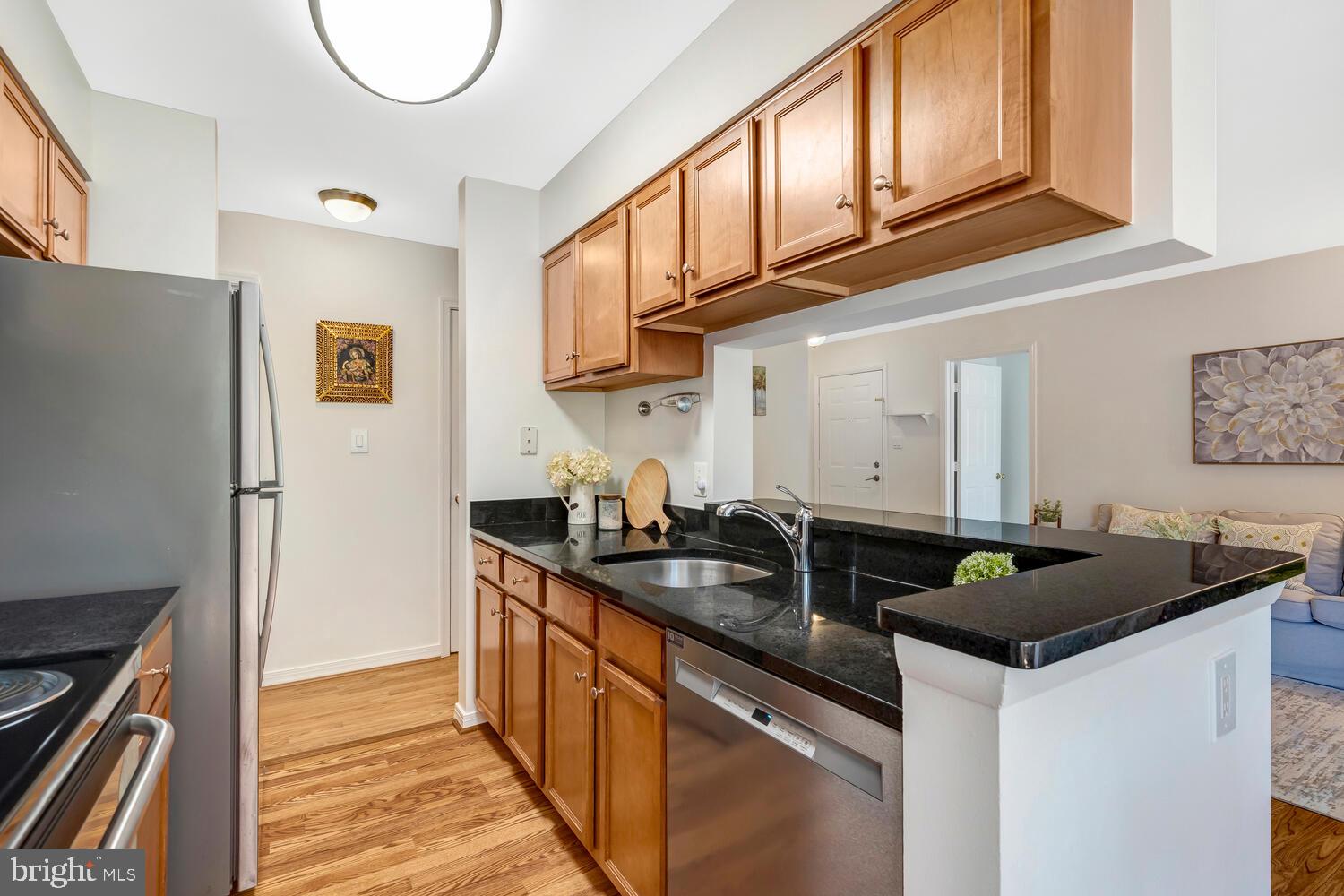 1791 Jonathan Way, Unit 1791C Reston, VA 20190 - Photo 13 of 58 a kitchen with granite countertop a sink and a stove