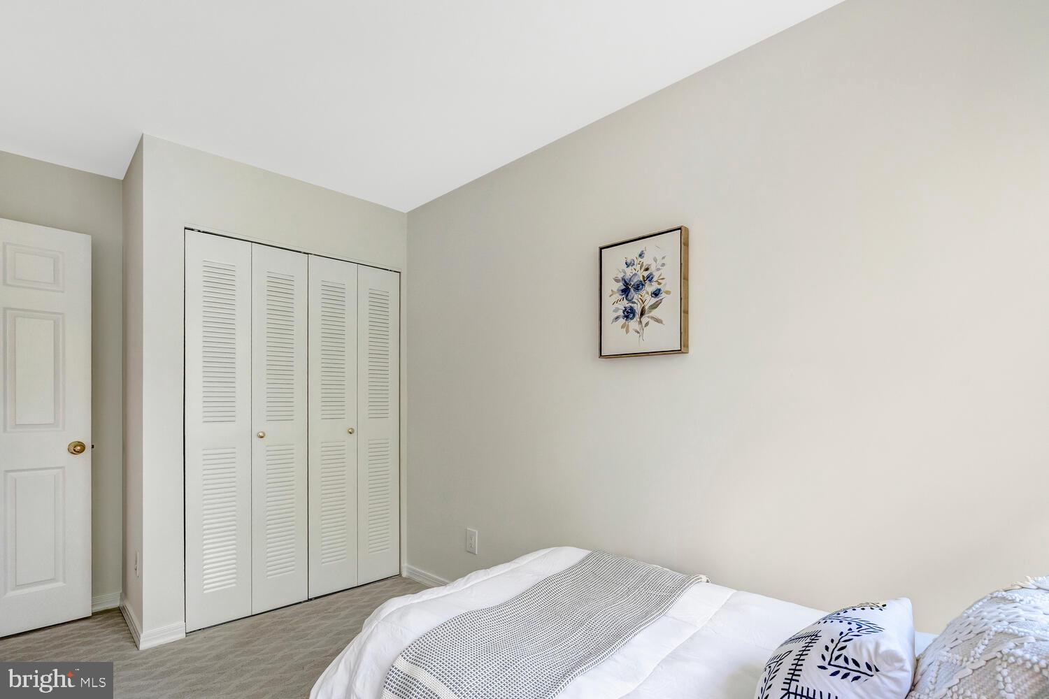1791 Jonathan Way, Unit 1791C Reston, VA 20190 - Photo 18 of 58 a bedroom with a bed and a painting on the wall