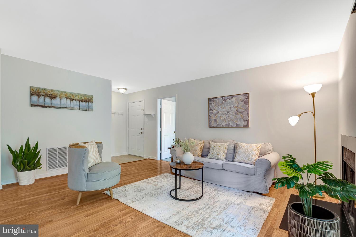 1791 Jonathan Way, Unit 1791C Reston, VA 20190 - Photo 2 of 58 a living room with furniture and a potted plant