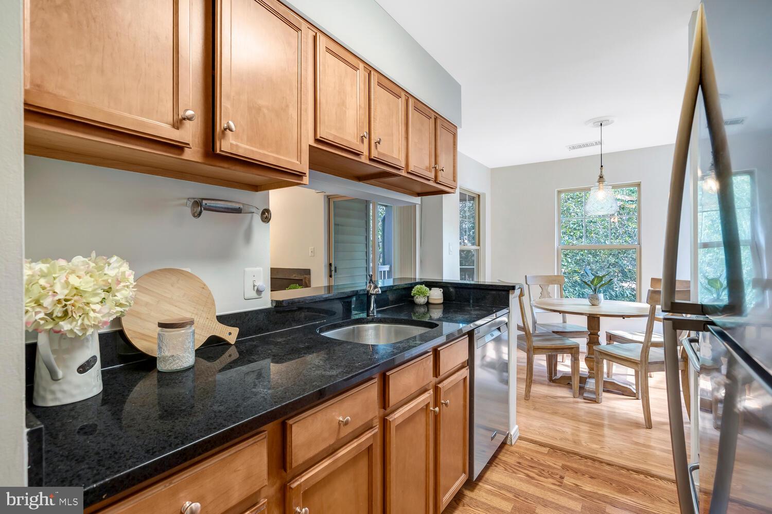1791 Jonathan Way, Unit 1791C Reston, VA 20190 - Photo 3 of 58 a kitchen with granite countertop a sink and a white wooden cabinets