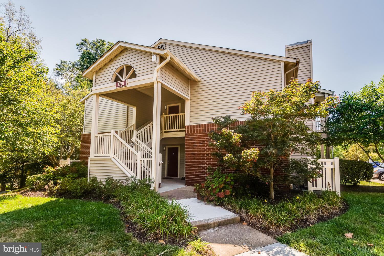1791 Jonathan Way, Unit 1791C Reston, VA 20190 - Photo 50 of 58 a front view of a house with a yard and trees