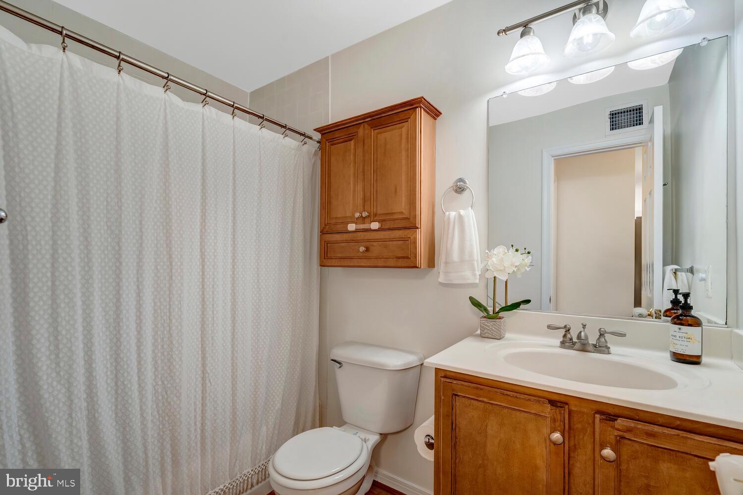 1791 Jonathan Way, Unit 1791C Reston, VA 20190 - Photo 8 of 58 a bathroom with a granite countertop sink vanity mirror and toilet