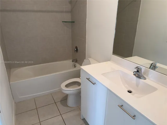 a bathroom with a sink a toilet and bathtub