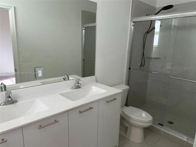 a white toilet sitting next to a bath tub