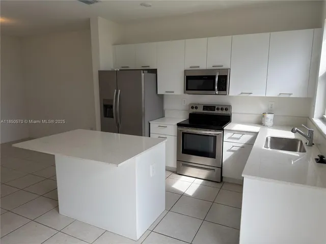 a view of a refrigerator in kitchen and furniture