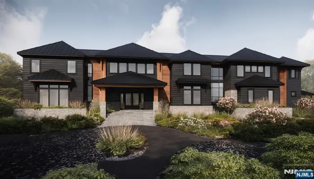 a front view of a house with a yard and table and chairs under an umbrella
