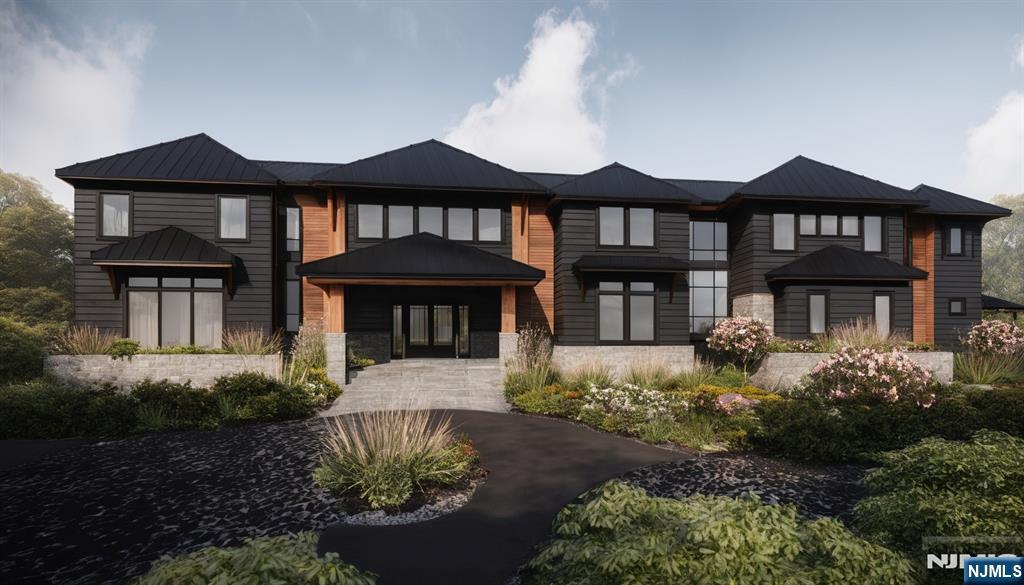 38 Cambridge Way Alpine, NJ 07620 - Photo 2 of 9 a front view of a house with a yard and table and chairs under an umbrella