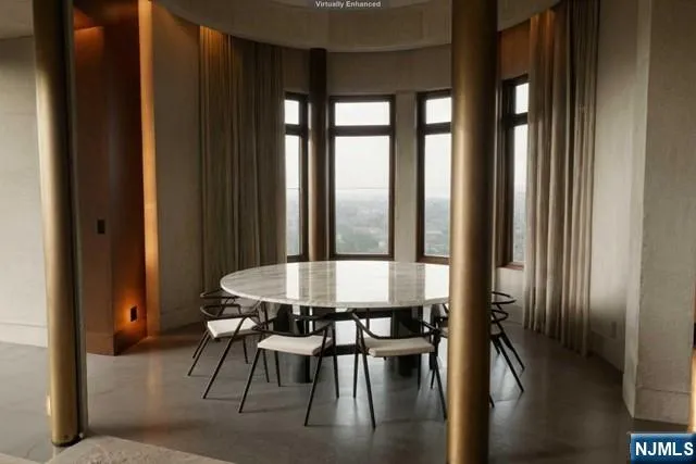 a view of a room with a table and chairs