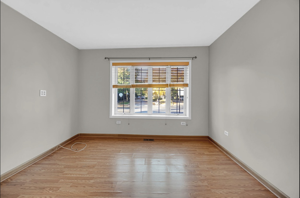 3329 South Racine Avenue Chicago, IL 60608 - Photo 22 of 33 an empty room with wooden floor and windows