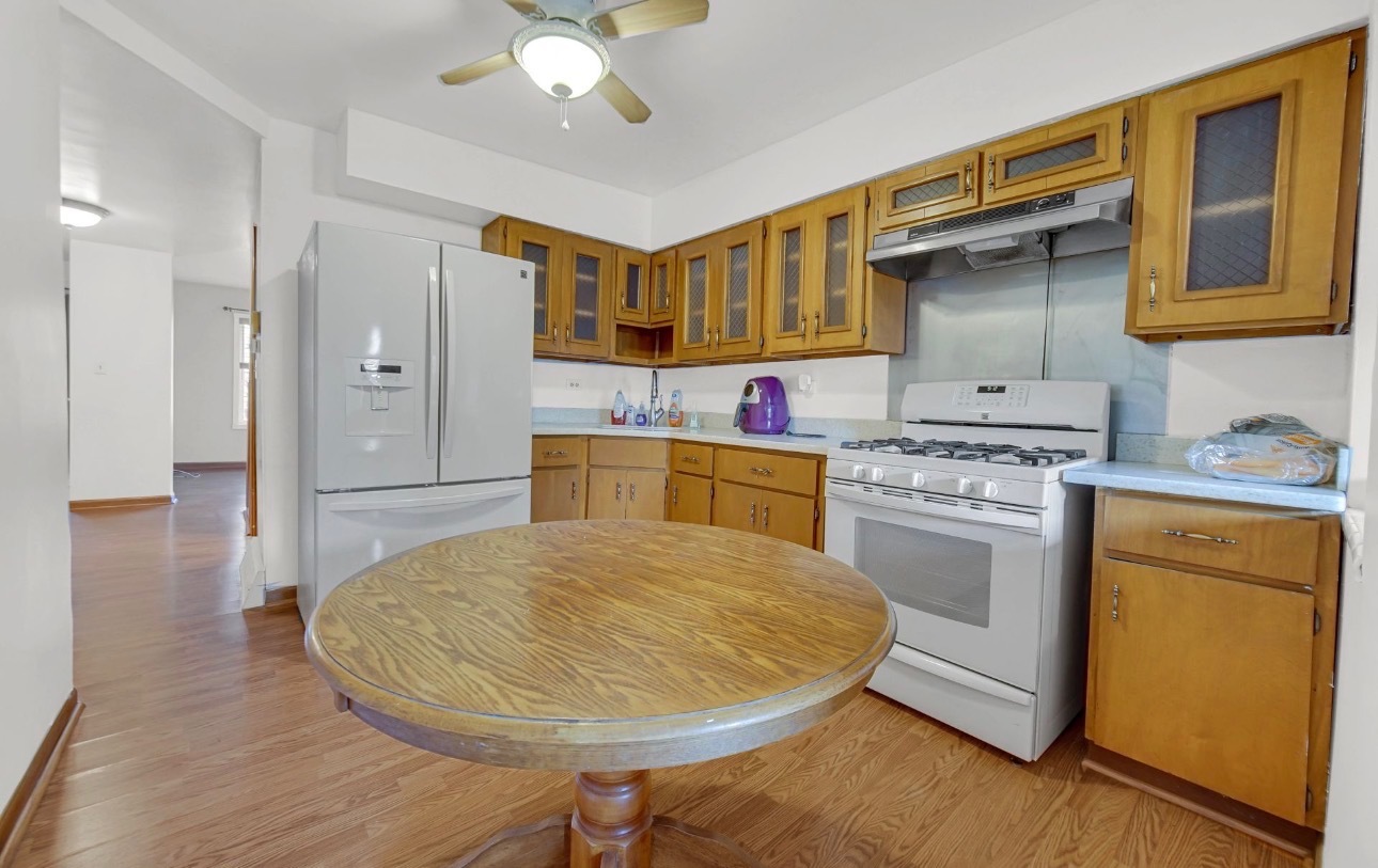 3329 South Racine Avenue Chicago, IL 60608 - Photo 4 of 33 a kitchen with a stove a refrigerator and a sink