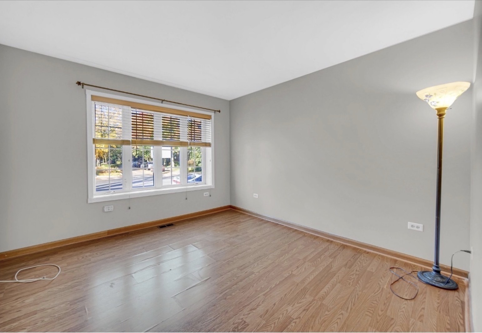 3329 South Racine Avenue Chicago, IL 60608 - Photo 10 of 33 a view of an empty room with a window and wooden floor