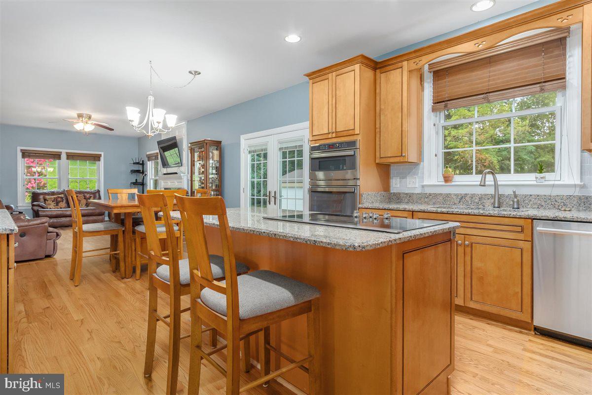 20239 Locust Grove Road Rohrersville, MD 21779 - Photo 18 of 51 a view of a dining room with furniture and chandelier