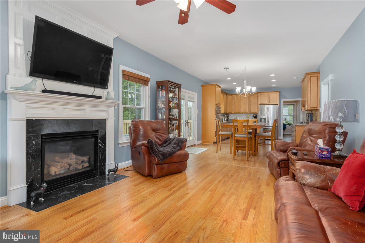20239 Locust Grove Road Rohrersville, MD 21779 - Photo 21 of 51 a living room with furniture fireplace and flat screen tv