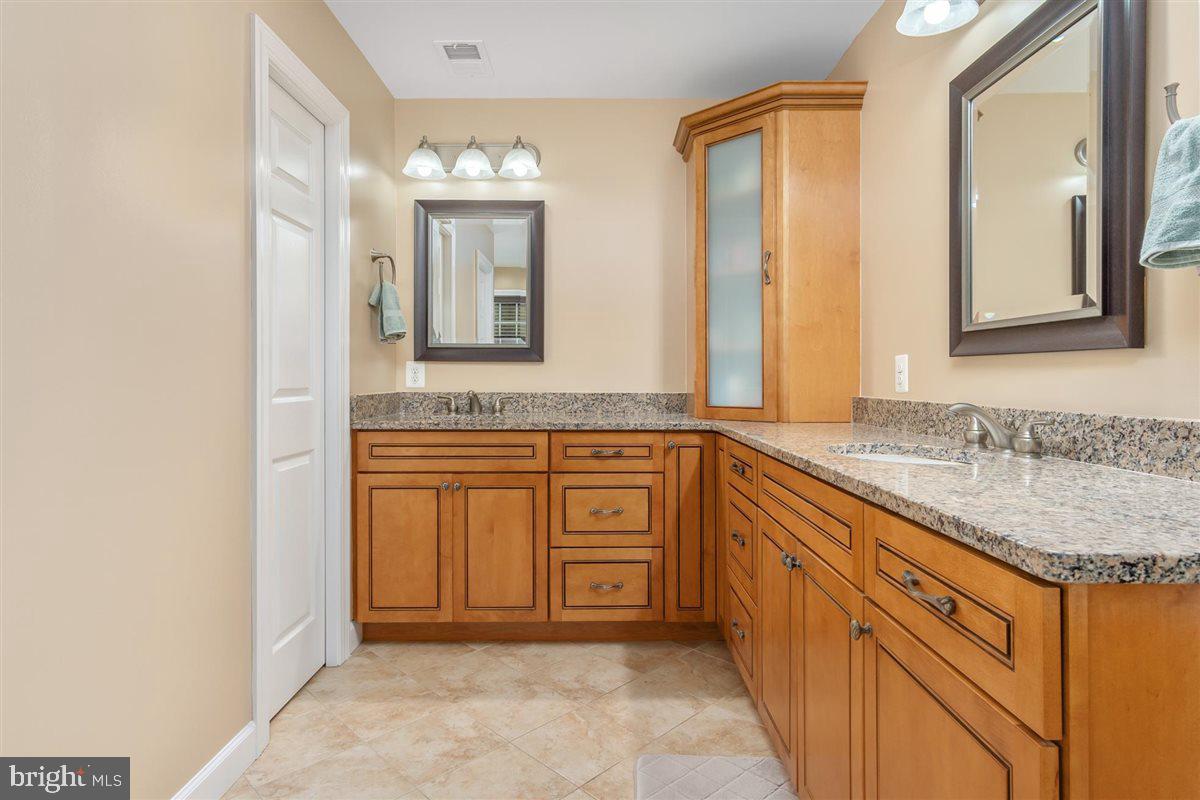20239 Locust Grove Road Rohrersville, MD 21779 - Photo 28 of 51 a bathroom with a granite countertop sink and a mirror