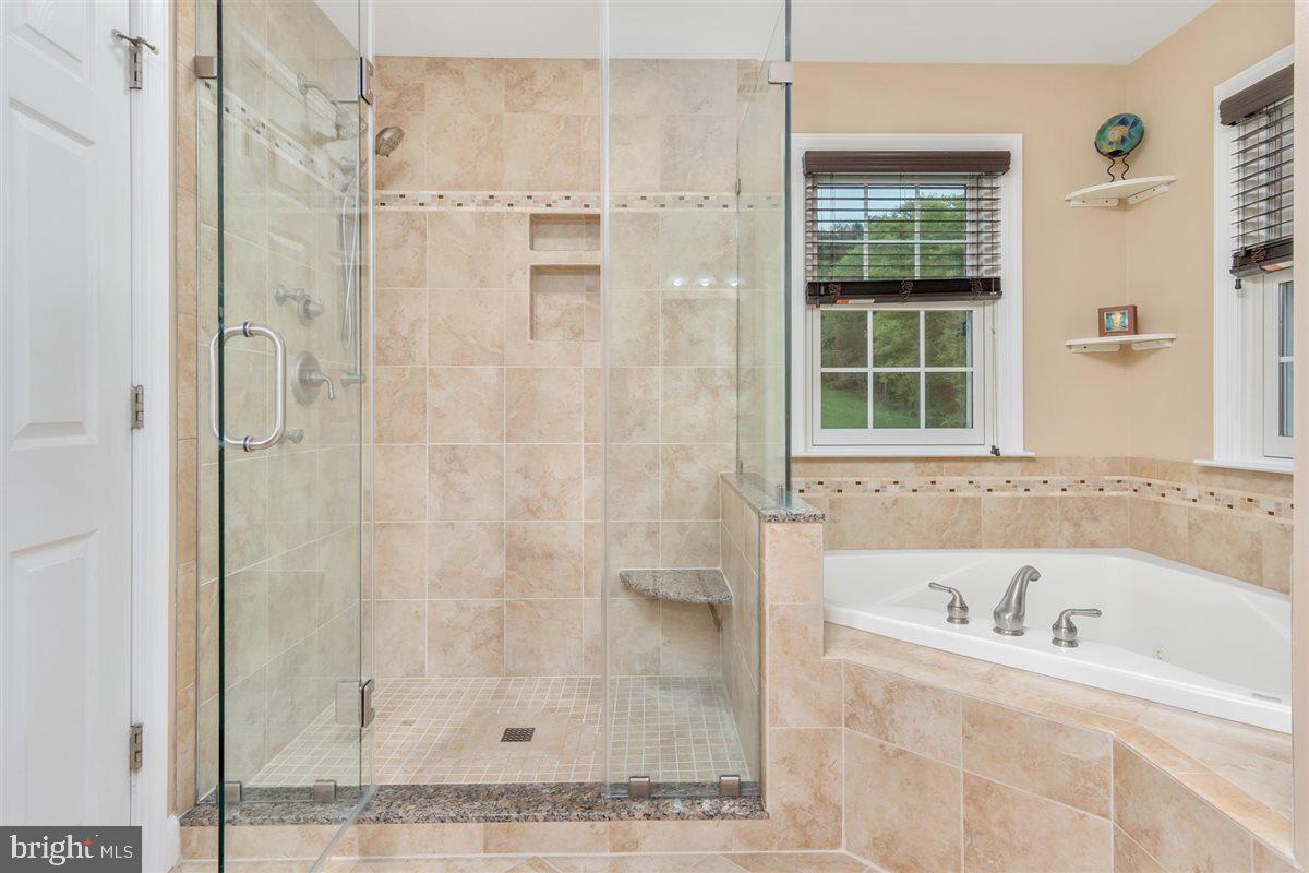 20239 Locust Grove Road Rohrersville, MD 21779 - Photo 29 of 51 a bathroom with a bathtub and a shower