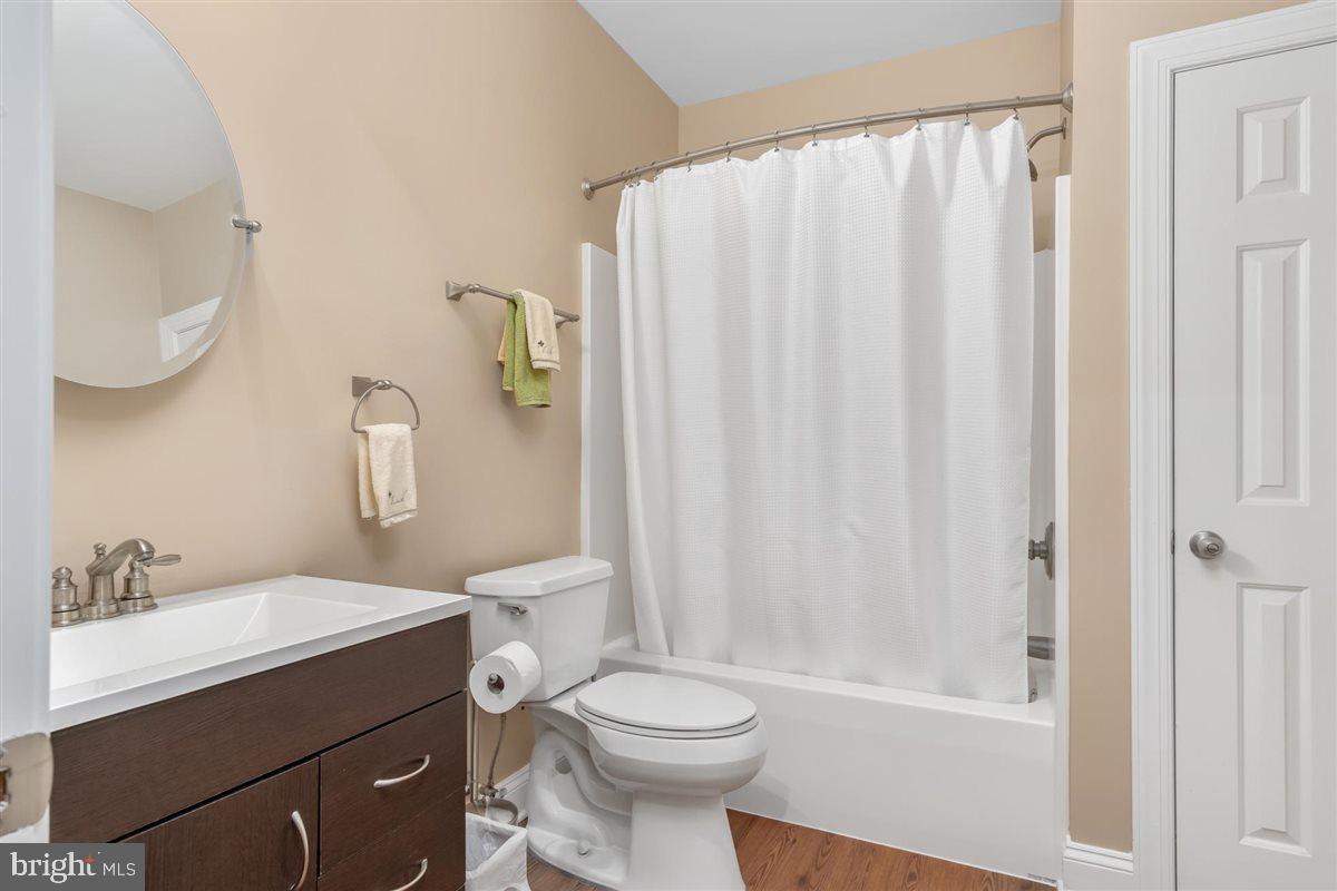 20239 Locust Grove Road Rohrersville, MD 21779 - Photo 42 of 51 a bathroom with a sink a toilet and shower curtain