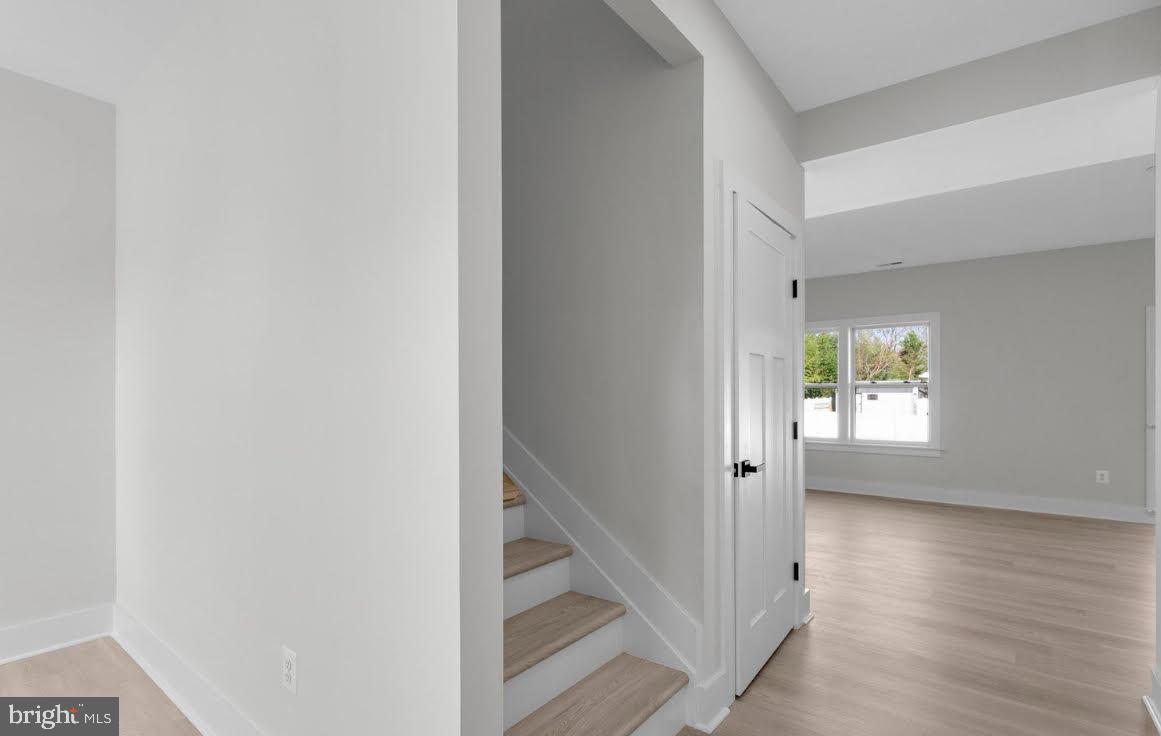 4938 Rullman Road Shady Side, MD 20764 - Photo 12 of 29 a view of an empty room with wooden floor and a window