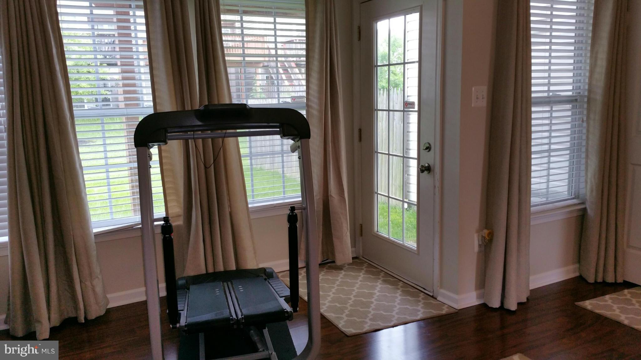 917 Tipton Road Baltimore, MD 21220 - Photo 19 of 24 an empty room with wooden floor and windows